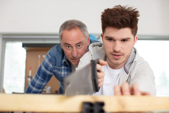 male apprentice carpenter learning the trade