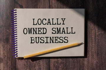 Closeup on businessman holding a card with text LOCALLY OWNED SMALL BUSINESS