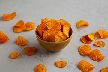 Homemade Flavored Paprika Potato Chips in a Bowl, side view.