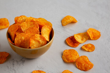 Homemade Flavored Paprika Potato Chips in a Bowl, side view.