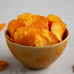 Homemade Flavored Paprika Potato Chips in a Bowl, side view. Close-up.