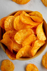 Homemade Flavored Paprika Potato Chips in a Bowl, top view. Close-up.