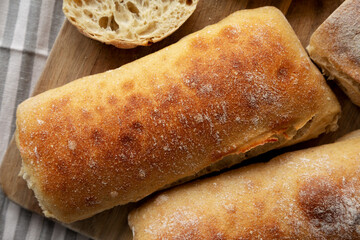 Homemade Sliced Ciabatta Bread on a wooden board, top view. Flat lay, overhead, from above. Close-up.