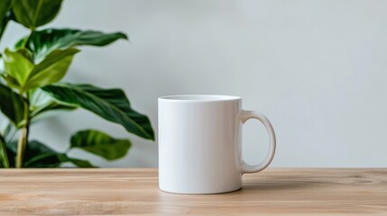 White mug on wooden table with plant.