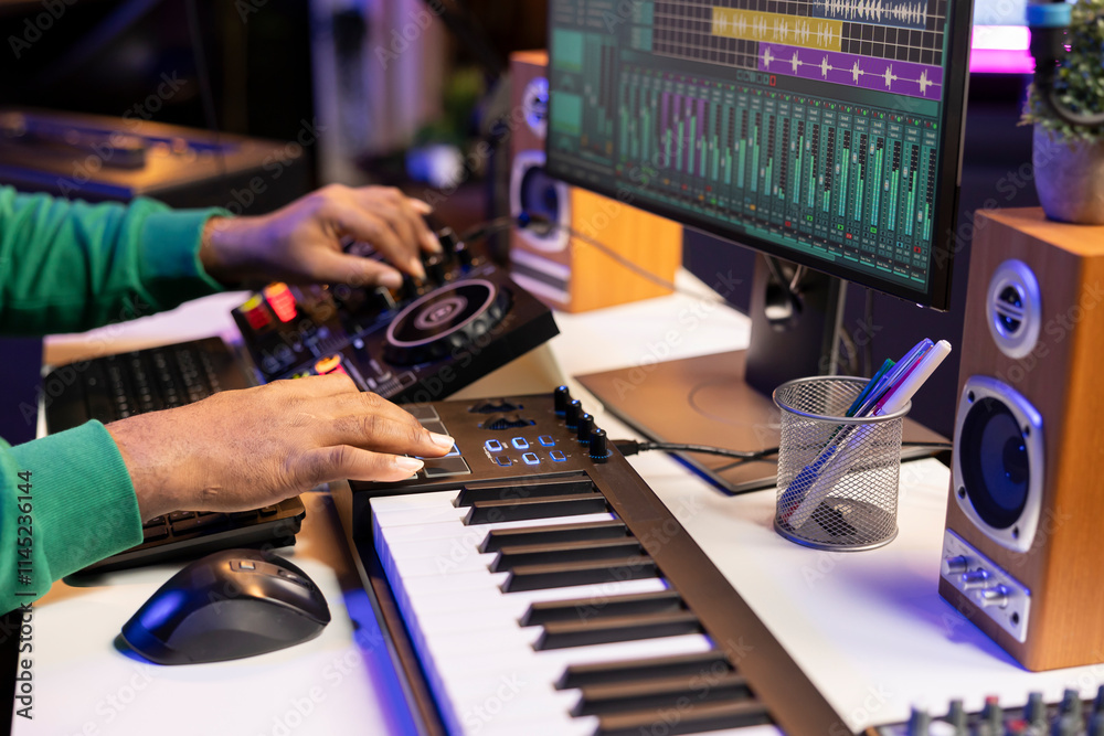Poster music producer twisting pre amp knobs on mixing console, editing his audio recordings in home studio
