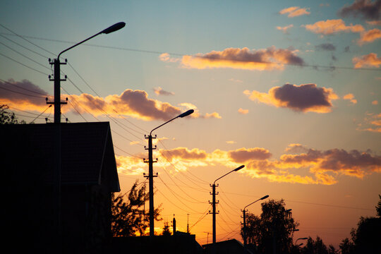 lamp posts silhouetted at sunset - Powered by Adobe