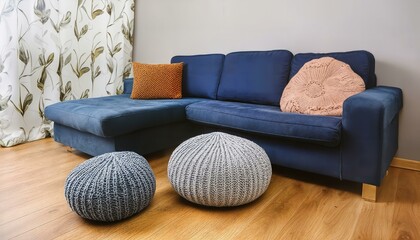 Cozy Scandinavian Home Interior Featuring Two Knitted Poufs Next to a Dark Blue Corner Sofa Modern Living Room Design Inspiration for a Stylish and Comfortable Space