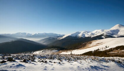 Fototapeta premium Breathtaking Wide Angle View of Majestic White Snowy Mountain Range Under a Clear Blue Sky During the Chilly Winter Season, Capturing Natures Serene Beauty and Tranquility