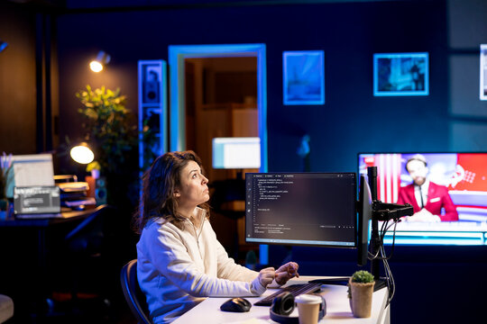 Developer in neon lit apartment implement security measures using augmented reality tech, protecting data. System administrator working from home, debugging code, looking at AR visualization