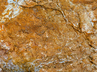 Background of stone texture that is mustard coloured with white veins