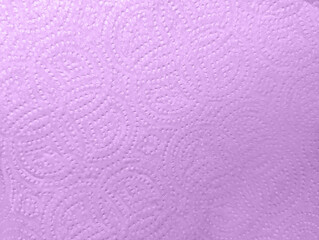 Close-up macro view of violet embossed kitchen paper towel texture details with circular patterns design. Soft textured absorbent material for households cleaning and wiping surfaces efficiently.