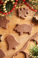 Shapes cut out from raw pastry dough - preparation of homemade gingerbread Christmas cookies, top view