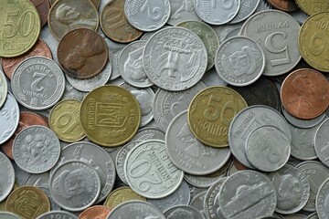 Big pile of different coins from various currencies and different countries around the world. Currency exchange