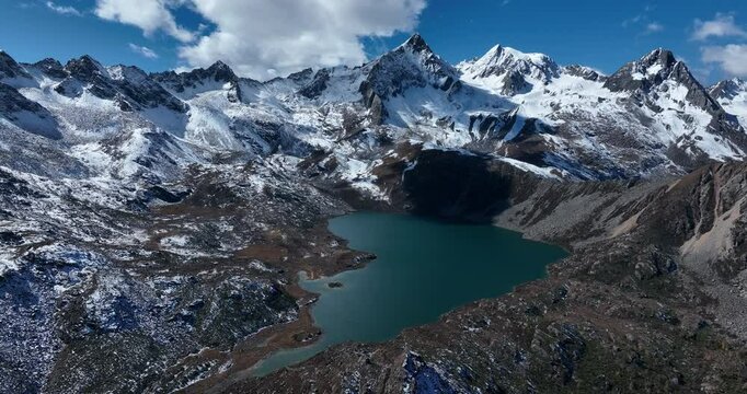 Aerial footage of beautiful high altitude mountains and lake landscape