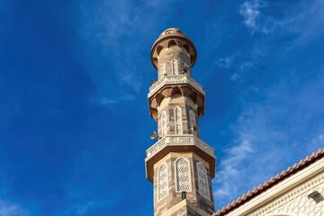 Architectural marvel of an ornate minaret against a clear blue sky
