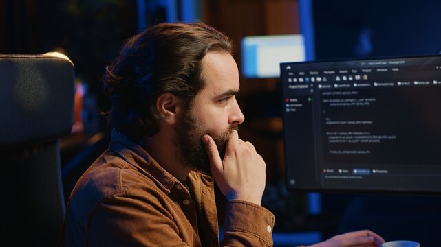 Computer scientist drinking cup of coffee while developing code on PC using java programming languages. IT admin brainstorming ways of fixing database errors, enjoying hot beverage, camera A
