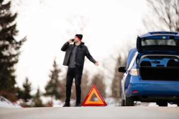 Displeased man breaks down car in the middle of trip on the road calls tow truck to come repair...