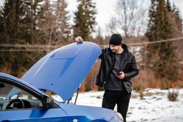 Displeased man breaks down car in the middle of trip on the road calls tow truck to come repair...