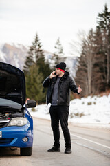 Displeased man breaks down car in the middle of trip on the road calls tow truck to come repair...