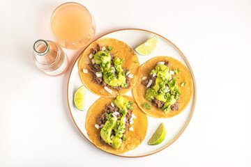 Barbacoa Meat Tacos with avocado salsa and Guava Juice Drink, view from above