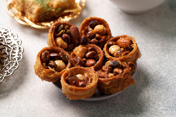 Traditional dessert with nuts and crispy pastry served on a plate at a cultural gathering
