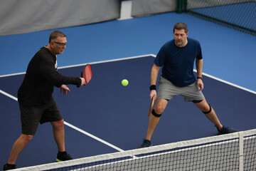 Pickleball doubles played indoors