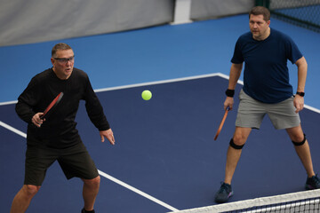 Pickleball doubles played indoors