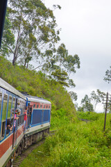 Obraz premium Colonial train route built by the British Empire, offering a journey through history, stunning mountains, waterfalls, and tea estates—Ella Odyssey train journey 2024.12.13 Ella Sri Lanka