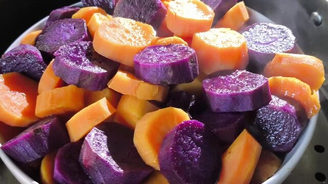 Steaming  sweet potatoes in pot, in door  Chiangmai  Thailand.