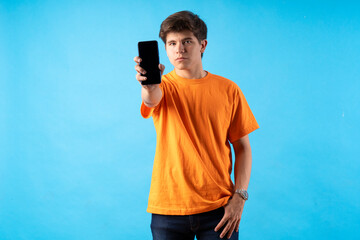 Young person expressing various emotions and body pains, pointing, using a cellphone, with colored backgrounds and wearing shirts of different colors