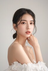 Portrait of a beautiful asian korean woman in a clean white dress.