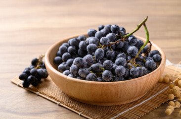 Black grapes in wooden bowl, Seedless grapes