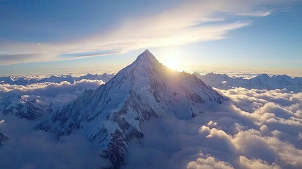Majestic mountain peak above clouds at sunrise