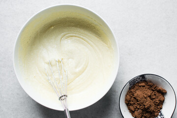Creaming butter sugar and egg with a whisk, the process of making a cake, mixing butter and sugar to make a cake