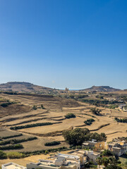 Hills with church visible in distance - panoramic view from the Old medieval citadel, Gozo island