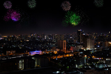 Bangkok Thailand skyline with fireworks over city at twilight.