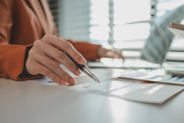 employees sit in an office with a pile of documents that need to be completed before work ends, entrepreneurs are planning their work to prepare for presentation to investors