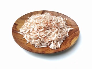 Dried salted baby shrimp on plate isolated on white background 