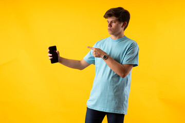 Young person expressing various emotions and body pains, pointing, using a cellphone, with colored...