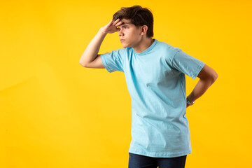 Young person expressing various emotions and body pains, pointing, using a cellphone, with colored backgrounds and wearing shirts of different colors