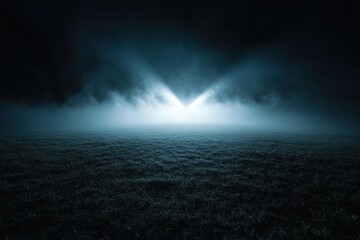 A mysterious landscape illuminated by light through fog, creating an eerie atmosphere.