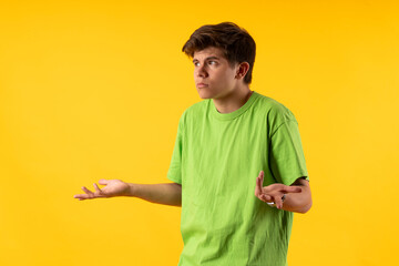 Young person expressing various emotions and body pains, pointing, using a cellphone, with colored backgrounds and wearing shirts of different colors