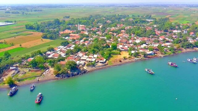 The coastline of a small town in East Java. This is one of the fishing villages in the area. Producing snacks from seafood, the name of the food is rengginang. This video was taken using a 4k aerial.