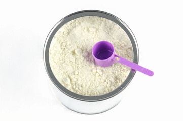 powder formula milk and purple spoon