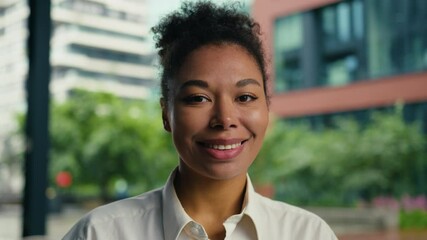 Happy African American woman looking at camera smiling toothy dental smile positive female girl businesswoman outdoor joyful portrait ethnic face manager employer entrepreneur expression business city