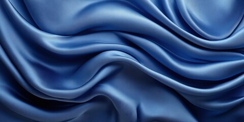 Obraz premium Smooth flowing fabric texture in vibrant blue tones with abstract curves, highlighting modern elegance and artistic design