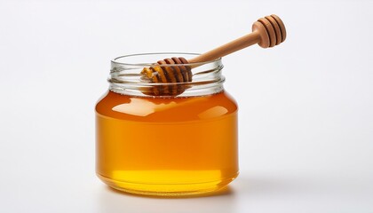 Golden honey in a glass jar with a wooden honey dipper.