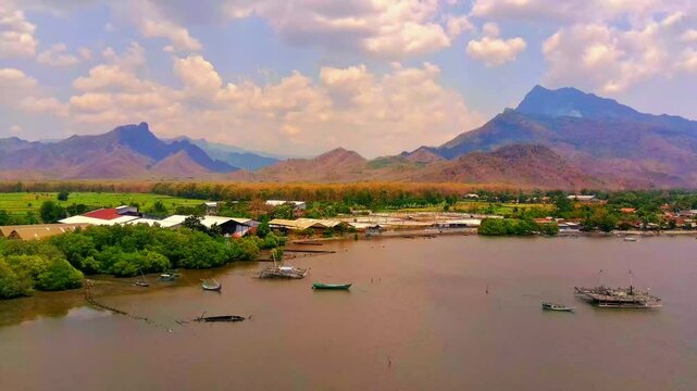 Coastal village with beautiful mountain views. Located in Situbondo City, East Java. This video footage was taken using a 4k aerial drone in the morning.