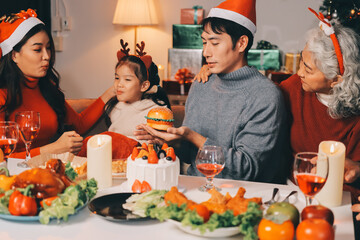 Happy multigeneration family enjoying in opening gifts on Christmas eve at home.