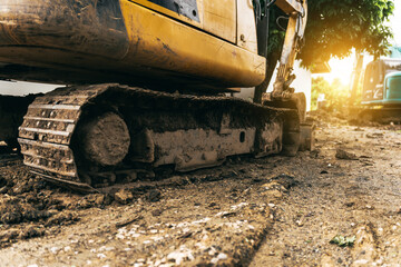 A yellow excavator focuses on its metal bucket teeth,digging soil at a construction site.This earth-moving machinery,including loaders and backhoes,is essential for excavation and earthwork projects